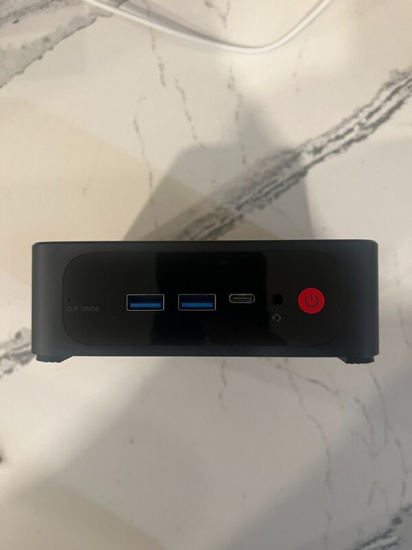 NodeAxe Sovereign Node — Reference Prototype NodeAxe reference mini PC prototype, front view with USB ports and red power button; final production model to be confirmed